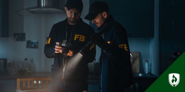 Two FBI criminal investigators in a dark room